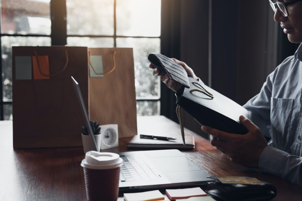 man holding a gift bag with a necktie inside out as a gift at the cafe